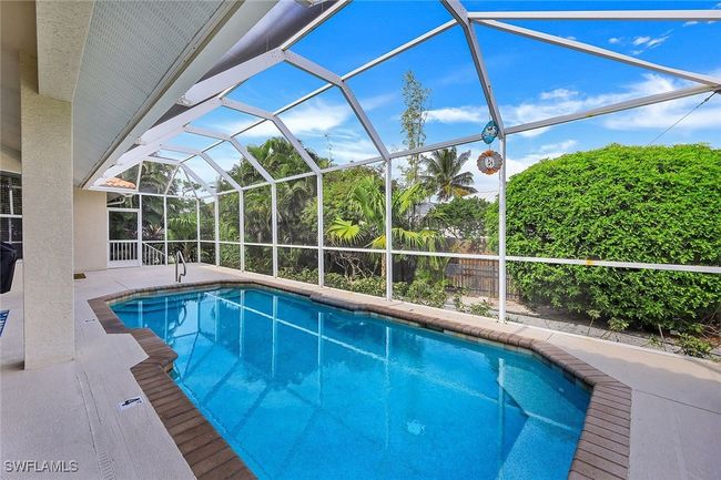 View of pool with a patio area and a lanai | Image 20