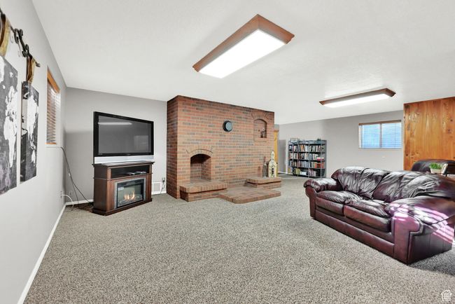 Living room featuring carpet and a fireplace | Image 28