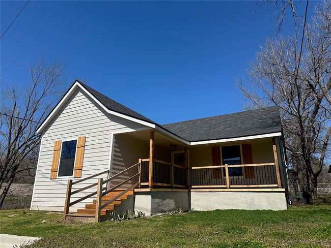 View of front of property with a front yard, a porch, and roof with shingles | Image 25