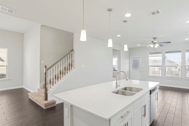 Kitchen featuring plenty of natural light, wood tiled floors, light countertops, and recessed lighting | Image 12