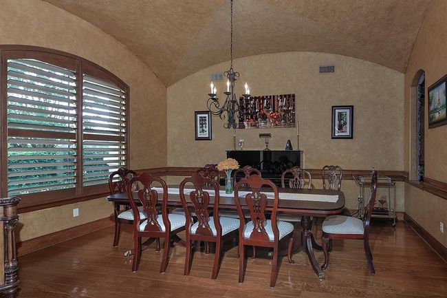 Generous dining room with a vaulted ceiling, wood trim accents is an ideal place to gather and entertain | Image 7