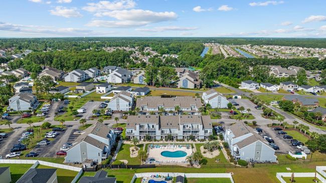 Aerial overview of property's location featuring a pool area and nearby suburban area | Image 29