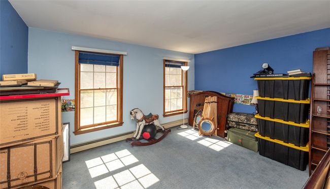 Bedroom featuring a baseboard radiator and carpet flooring | Image 35