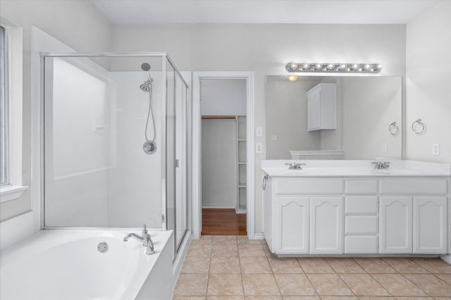 Spacious primary bathroom with separate shower and tub and a large walk-in closet | Image 14