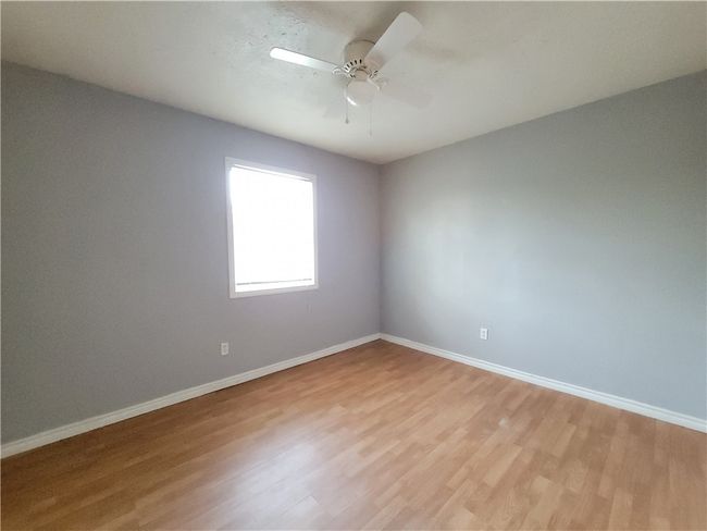 Spare room with light wood-style floors and ceiling fan | Image 8