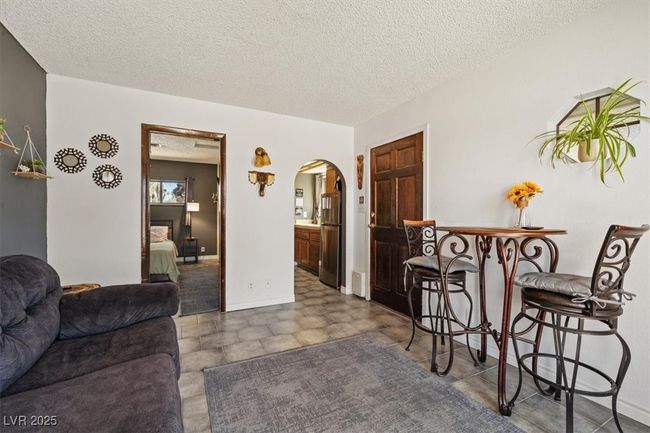 Living room in casita with arched walkways and a textured ceiling | Image 39
