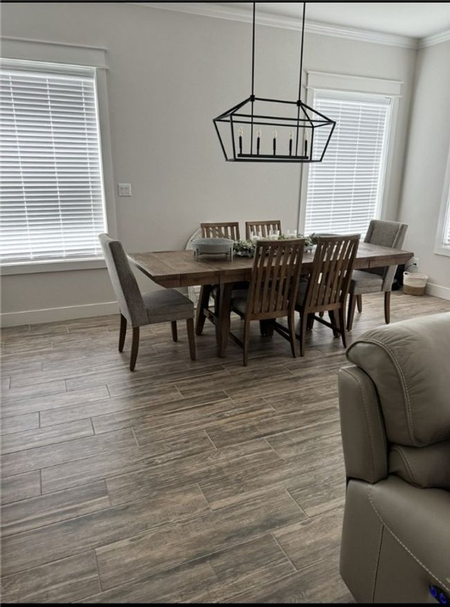 Dining space with a chandelier, crown molding, and dark wood finished floors | Image 16