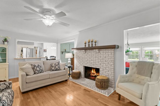 family room open to the kitchen with gas log fireplace. | Image 9