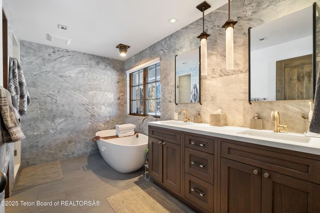 Recently remodeled spa bathroom with luxurious tile walls, heated floors, plato cabinetry, and a new Barcelona Contemporary bathtub. | Image 20