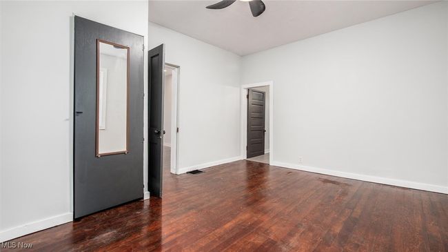 Bedroom 1 featuring dark wood-type flooring and a ceiling fan | Image 9