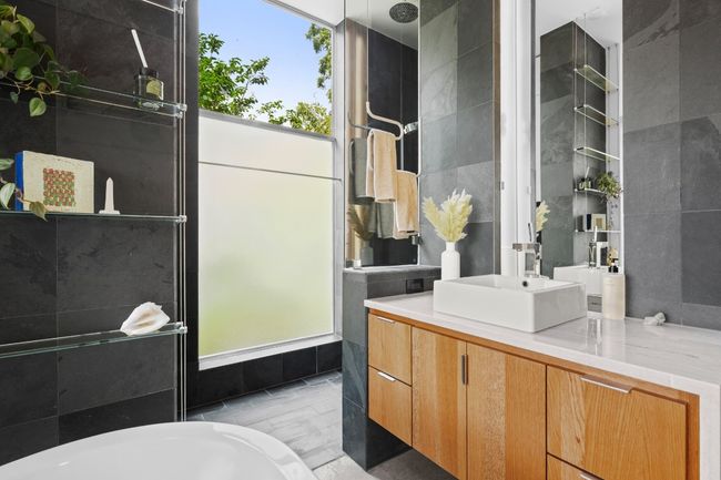 Full bathroom in the secondary bedroom- walk in shower, luxury soaking tub and Armani Brazillian waterflow countertops. | Image 29