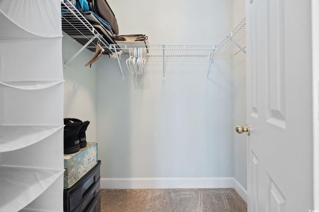 Spacious closet with carpet floors | Image 33