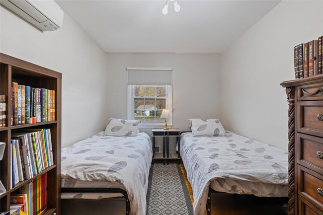 Bedroom featuring a wall mounted air conditioner | Image 25