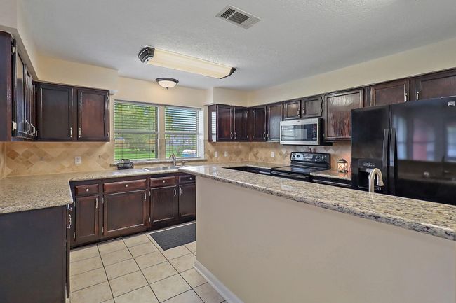 Kitchen with Plenty of Cabinet Storage | Image 12