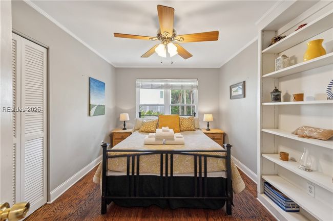 Second bedroom with stylish built in shelving, ample natural lighting if desired, hardwood floors. | Image 49