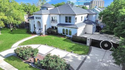 Stunning curb appeal for this luxury home in the heart of Houston! Circle drive with stately private gate and modern architecture along with lush landscaping and fountain create a warm welcome to this exquisite property. | Image 2