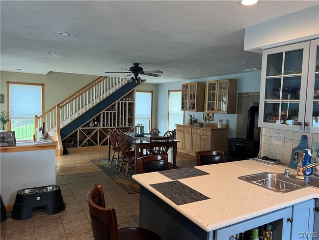 kitchen showing stairs to bedrooms and office area on second floor | Image 12