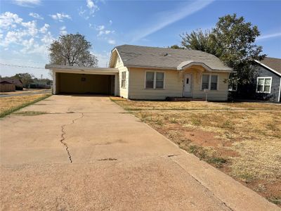 Single story home with a front lawn and a carport | Image 2