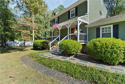 View of front of home featuring a front yard and covered porch | Image 2