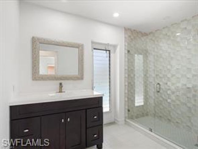 Bathroom with vanity with extensive cabinet space, walk in shower, and tile flooring | Image 18