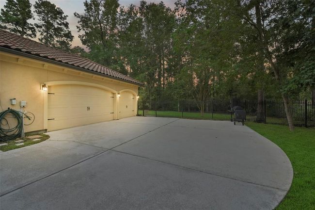 Spacious triple-car garage with ample storage/workspace. | Image 45
