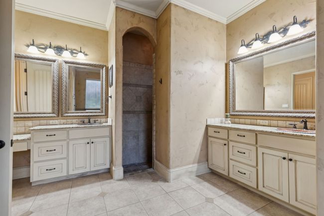 Full bath featuring two Granite vanities, tile patterned floors, separate shower with two shower heads (Rain) | Image 15