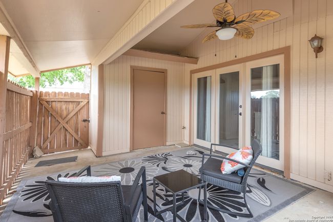 Relaxing and private back patio with ceiling fan. | Image 5