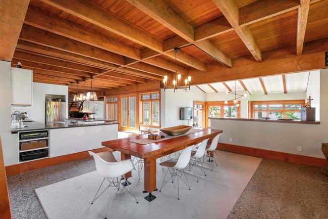 Dining area with a chandelier, wooden ceiling with exposed beams, plenty of natural light, and baseboards | Image 11