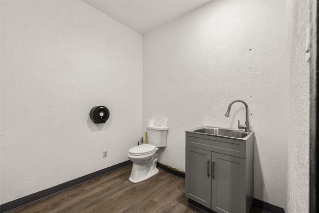 Half bathroom featuring toilet, wood finished floors, vanity | Image 54