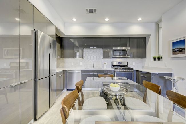 Kitchen with modern cabinets, appliances with stainless steel finishes, gray cabinetry, and recessed lighting | Image 11