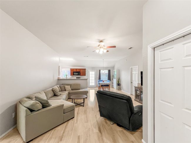 Living area featuring ceiling fan, light wood finished floors, and baseboards | Image 11