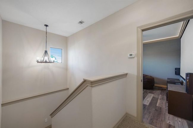 Upstairs landing there is a media room, storage closet and full door access to the attic | Image 30