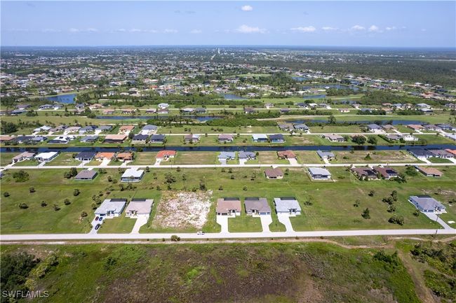 Aerial view of property's location with a large body of water and nearby suburban area | Image 37