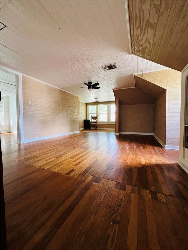 Unfurnished living room featuring wood ceiling, hardwood / wood-style flooring, and a ceiling fan | Image 24