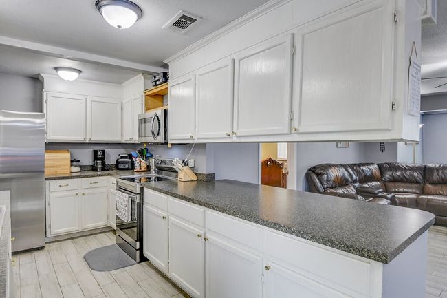Prepare meals while keeping an eye on the activity in the main living area | Image 12