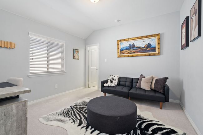 Carpeted living area with lofted ceiling and baseboards | Image 22