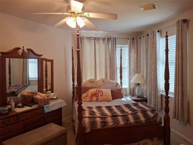 Downstairs Bedroom with baseboards, ceiling fan, and visible vents | Image 18