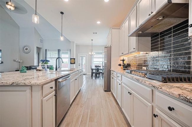 pen to the living and dining areas, this kitchen is perfect for hosting gatherings while staying connected | Image 13