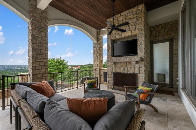 View of patio with an outdoor living space with a fireplace and a ceiling fan | Image 22