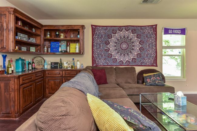 Living room with dark hardwood / wood-style flooring and bar | Image 8