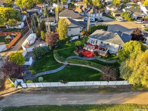Expansive green space with manicured lawn, stone pathway, and mature landscaping | Card Image