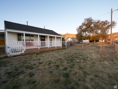 View of yard featuring a mountain view and covered porch | Image 2