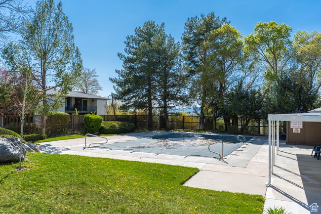 View of pool featuring fence and a yard | Image 33