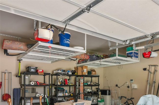 The garage features large overhead storage racks and the whole house Rain-soft water softener already included!! | Image 39