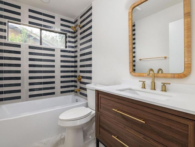 Bathroom featuring vanity and shower / washtub combination | Image 19