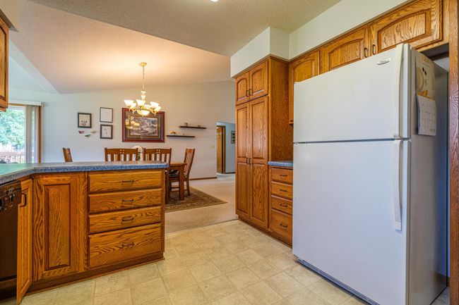 Kitchen features pantry with pull-outs. | Image 6