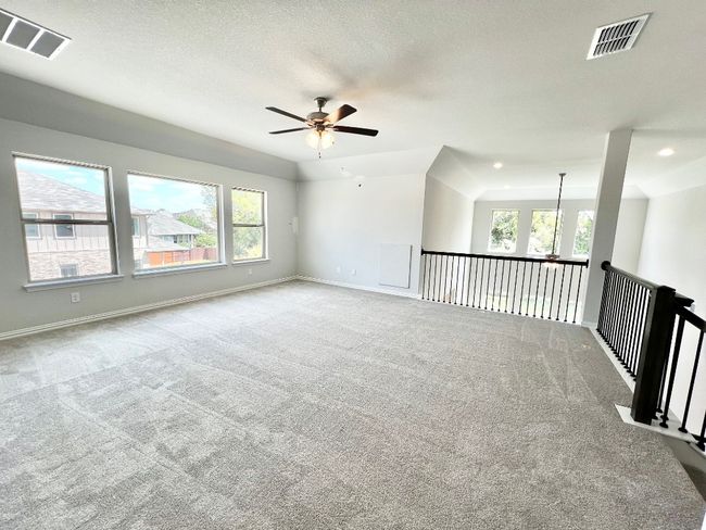 Carpeted spare room featuring a ceiling fan and a textured ceiling | Image 18