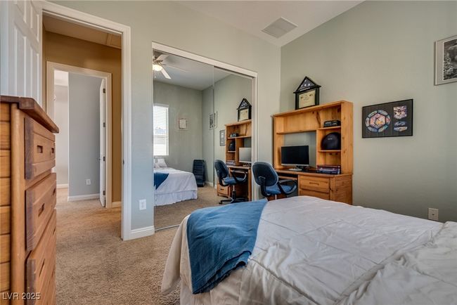 Bedroom with a closet, carpet floors, visible vents, and baseboards | Image 43