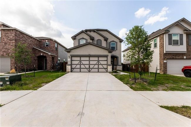 View of front of home featuring driveway, a front yard, and stucco siding | Image 30