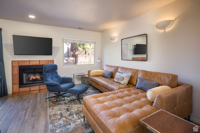 Living room featuring a fireplace and hardwood / wood-style flooring | Image 12